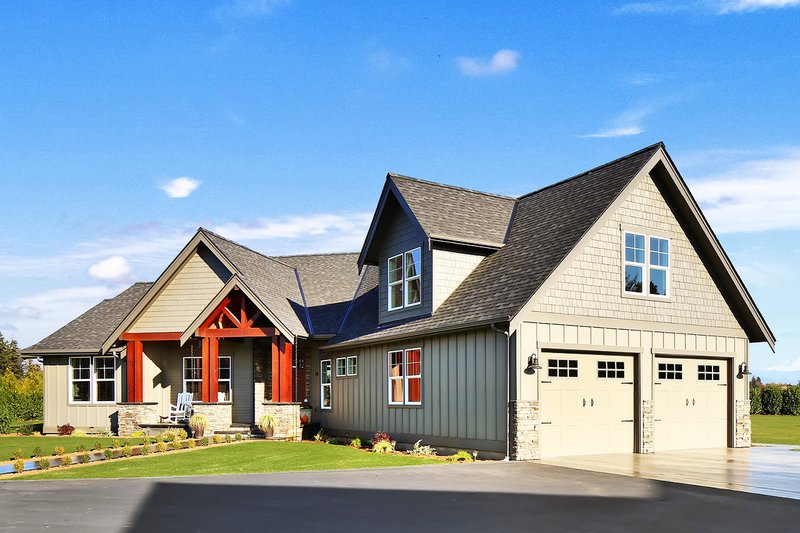 An example of a home that can be built in Legends Premium Estates: Gray home with wood trim accents.